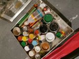 a box full of paint and other paints on the floor