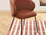 a chair that is sitting on a rug in a room