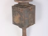 a small wooden pole with a metal object on top of it