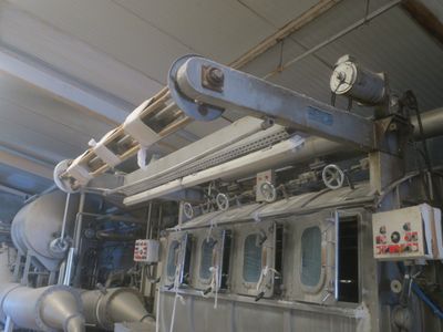 a machine that is inside of a building with pipes and valves