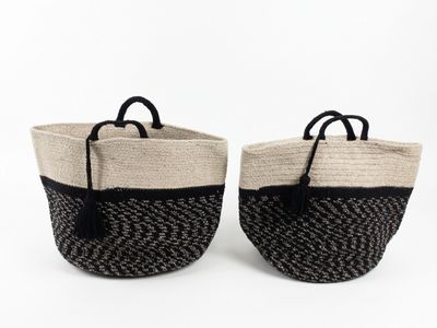 two black and white baskets with handles on a white background