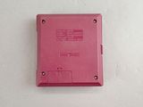 a pink electronic device sitting on a white surface