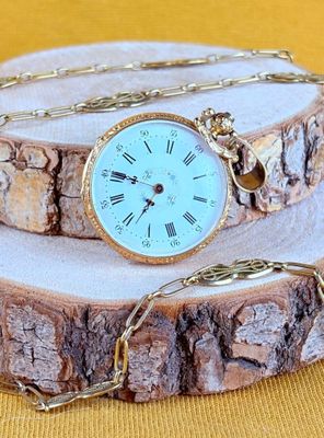 a clock that is sitting on a piece of wood