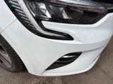 a close up of a white car that is parked in a lot