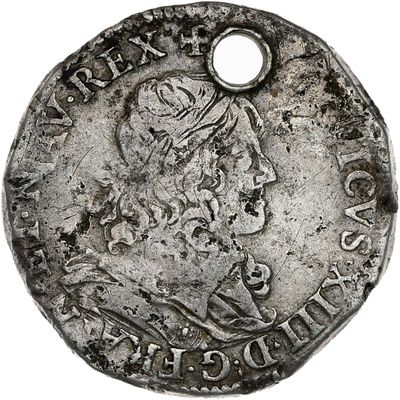 une pièce d'argent portant l'image d'un homme