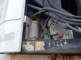 a truck with a bunch of wires attached to the back of it