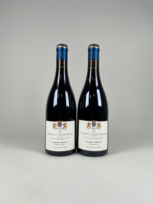 deux bouteilles de vin rouge posées l'une à côté de l'autre sur une table