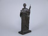bronze statue of a woman holding a sword and a book