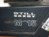 a picture of a black and orange machine with a sticker on it