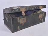 a black trunk with a blue blanket inside of it