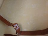 a tan hat with a brown leather belt on it