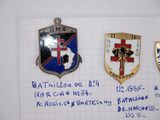 several badges are displayed on a piece of paper on a table