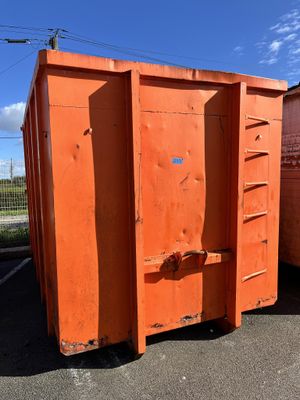two orange dumpsters in a parking lot next to each other