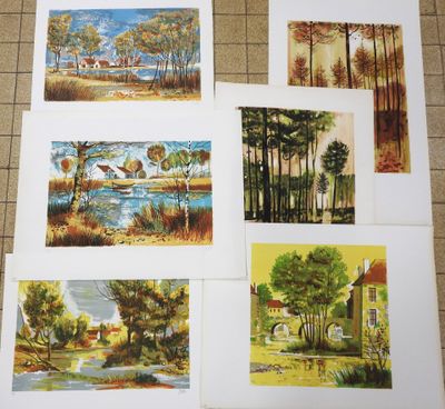 four paintings of different landscapes are displayed on a table