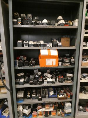 many different types of electronics on the shelves in this room