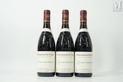 three bottles of wine are lined up on a white surface