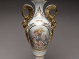 a white vase with a painting on it sitting on a table