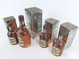 several bottles of liquor sitting next to each other on a white surface