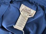a label on a blue jacket that says hermess