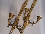 pair of antique brass wall sconces on a white background