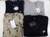 three men ' s polo shirts are sitting on a table next to each other