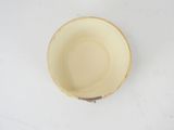 a white bowl with a brown rim on a white table
