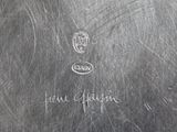 an antique silver plate with writing on it and a picture of a cat on it