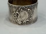 silver plated napkin ring with a heart and flowers on it
