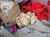 a suitcase full of clothes and a jacket in it