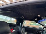 the interior of a car with the sunroof down and the passenger seat down