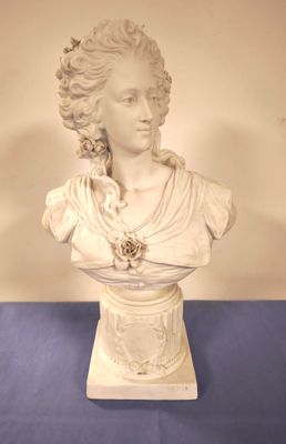 a statue of a woman with a flower in her hair