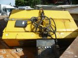 a yellow boat sitting on top of a pile of dirt