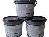 three buckets of white paint sitting on top of each other