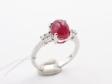 an oval ruby and diamond ring on a white background