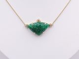 a green jade and diamond necklace on a gold chain