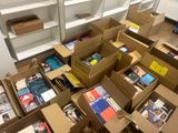 many boxes of books sitting on the floor in a room