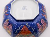 an image of a blue bowl with a design of a woman on it