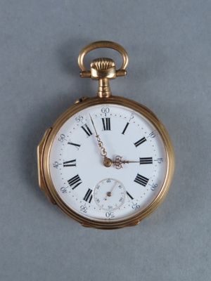a gold pocket watch with roman numerals on it