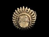 a close up of a gold ring with a stone in the center