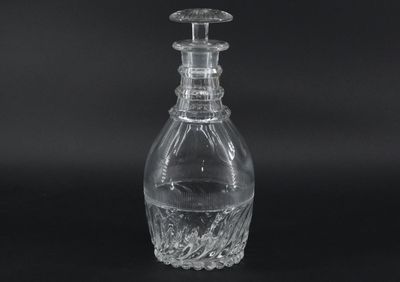 a close up of a clear glass bottle on a black background