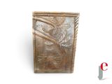 a metal plaque with a bird on it