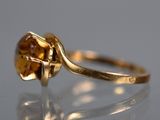 a close up of a gold ring with a citrine stone
