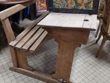 a small table and chairs in a room with a painting on the wall