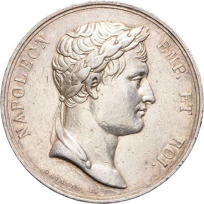 an old silver coin with a portrait of a man on it