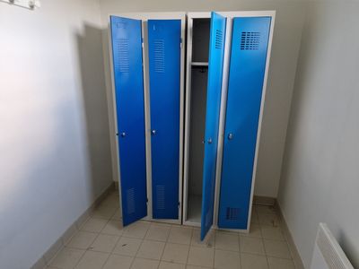 two blue lockers in the corner of a room