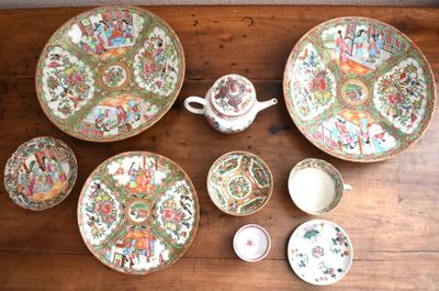 many plates and bowls sitting on a wooden table
