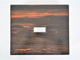 a small wooden box with a name plate on it