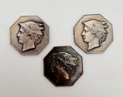 three different types of coins are shown on a white surface