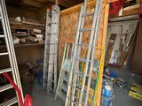 many ladders and tools in the garage of this house