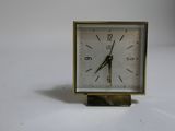 a small clock that is sitting on a table